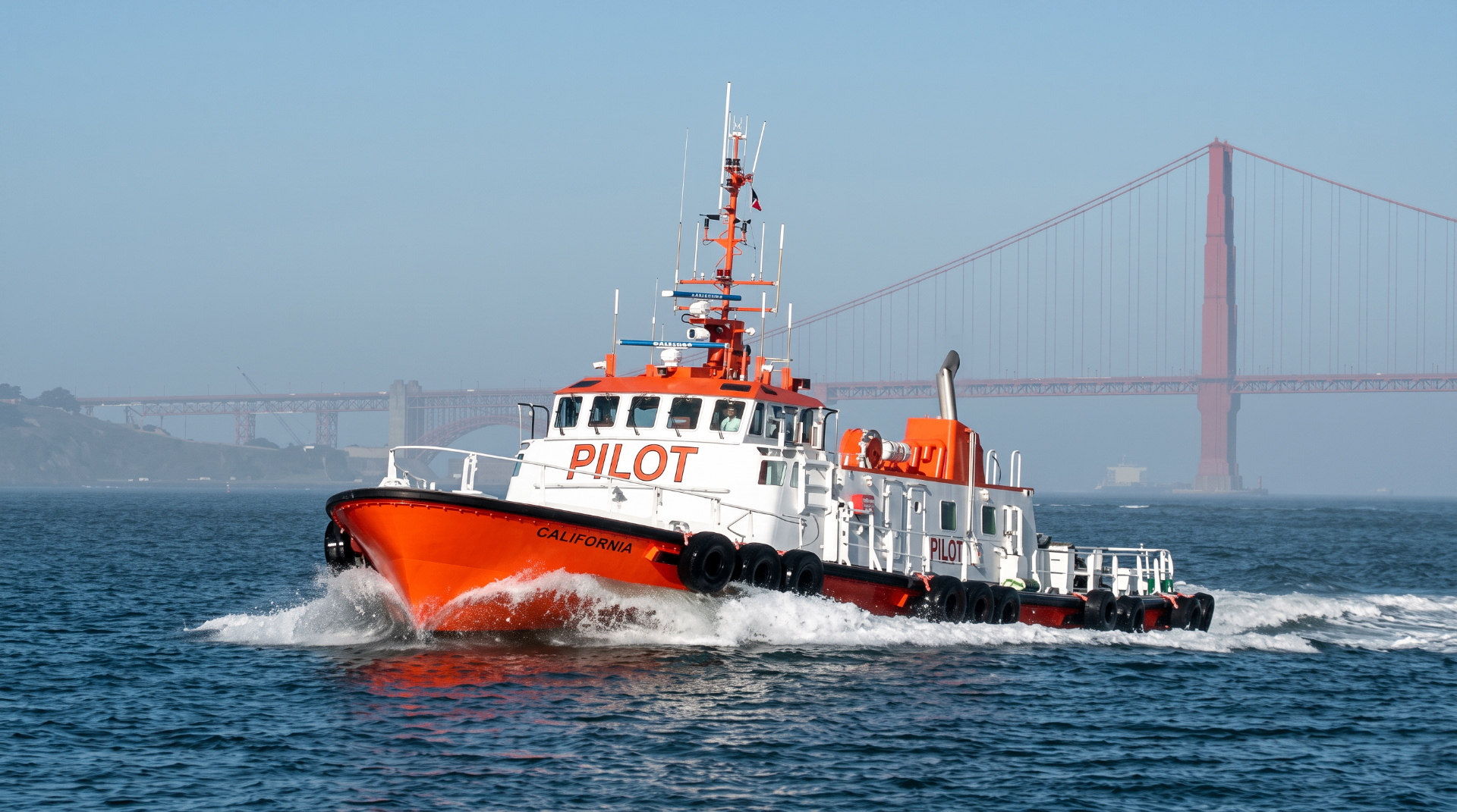 An orange and white San Francisco Bay pilot boat with the Golden Gate Bridge in the background
